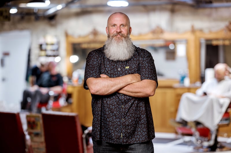 Brady McIntyre stands inside the Mac's Place barber shop.