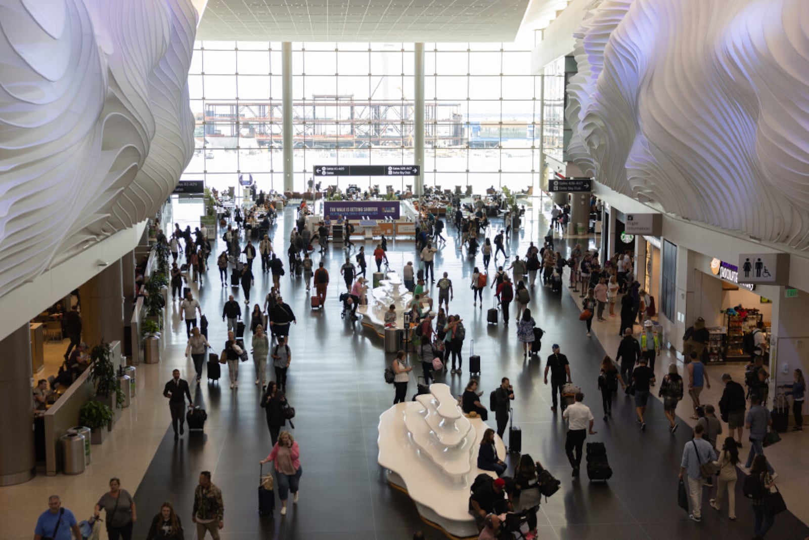 Travelers mingle in the terminal at the Salt Lake City International Airport in Salt Lake City in May 2023. | Photo by Ryan Sun, Deseret News